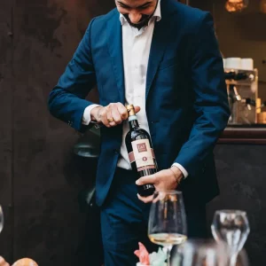 a sommelier opening a bottle of wine