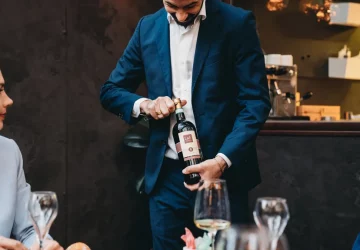 a sommelier opening a bottle of wine