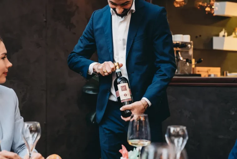 a sommelier opening a bottle of wine