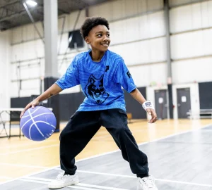 a young boy playing basketball