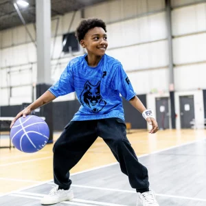 a young boy playing basketball
