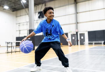 a young boy playing basketball