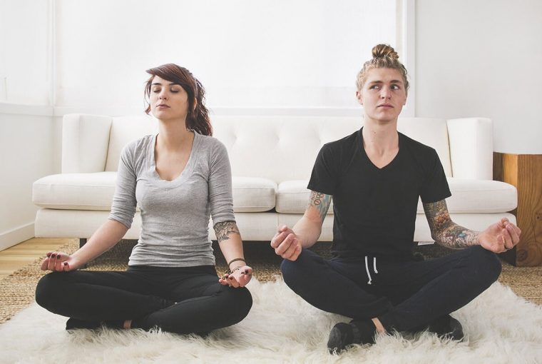 a couple in lotus position relaxing