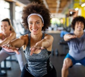 a group of adults taking agroup fitness class.