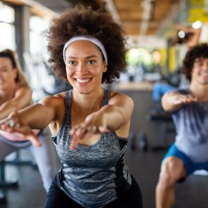 a group of adults taking agroup fitness class.