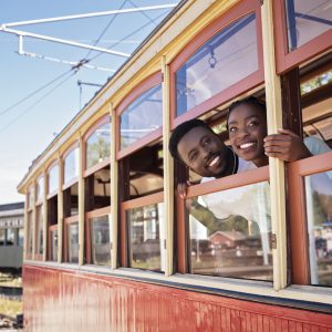 a couple lookin gout the window of a train car