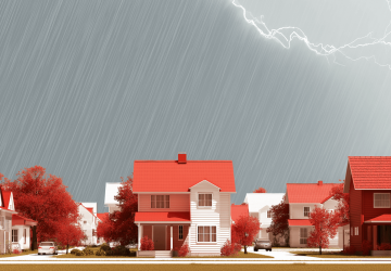an assortment of homes in front of dark clouds