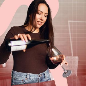 a woman pouring a glass of red wine