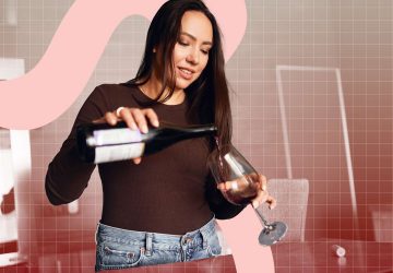 a woman pouring a glass of red wine