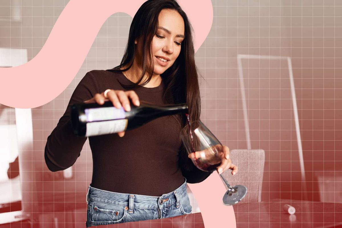 a woman pouring a glass of red wine