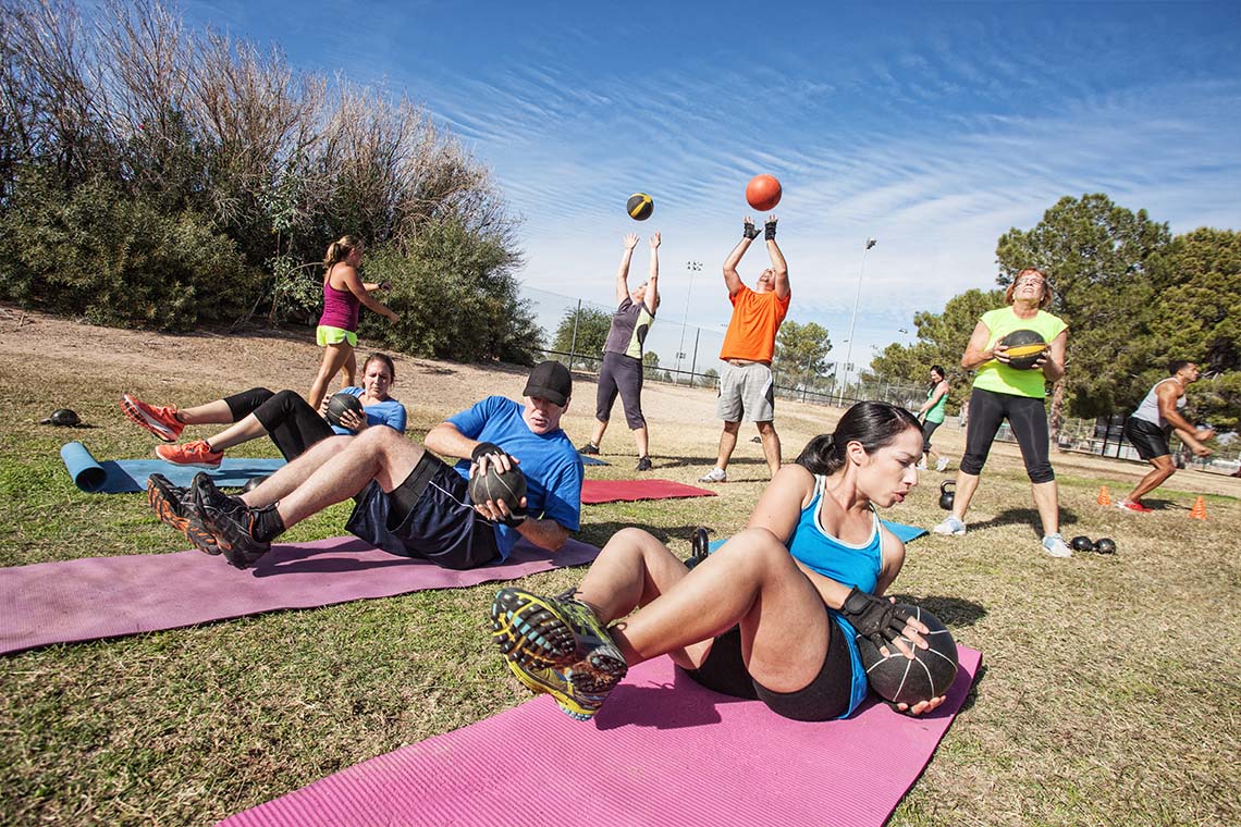a group of people working out outdoors