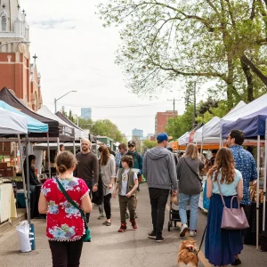 a crowd walking through the farmers market