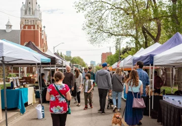 a crowd walking through the farmers market