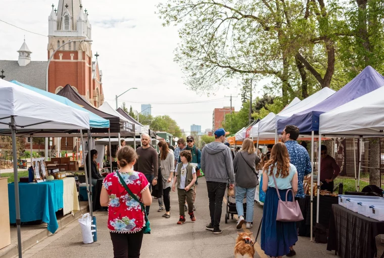 a crowd walking through the farmers market