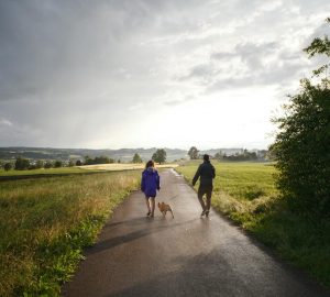 a couple walking their dog