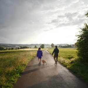 a couple walking their dog