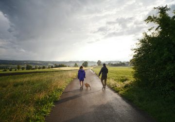 a couple walking their dog