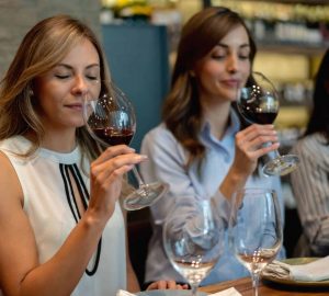 a group of women tasting wine