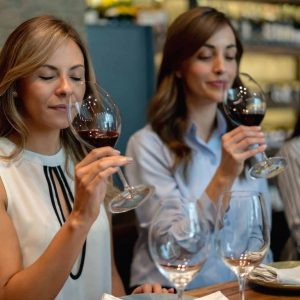 a group of women tasting wine