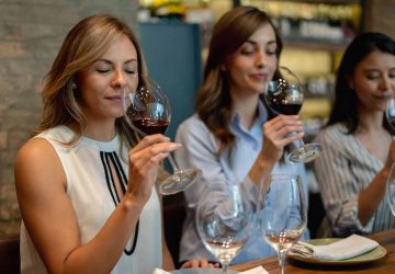 a group of women tasting wine