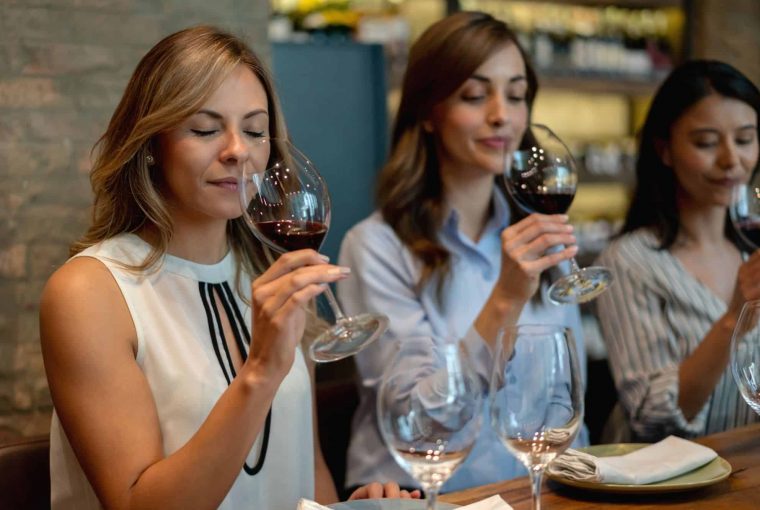 a group of women tasting wine
