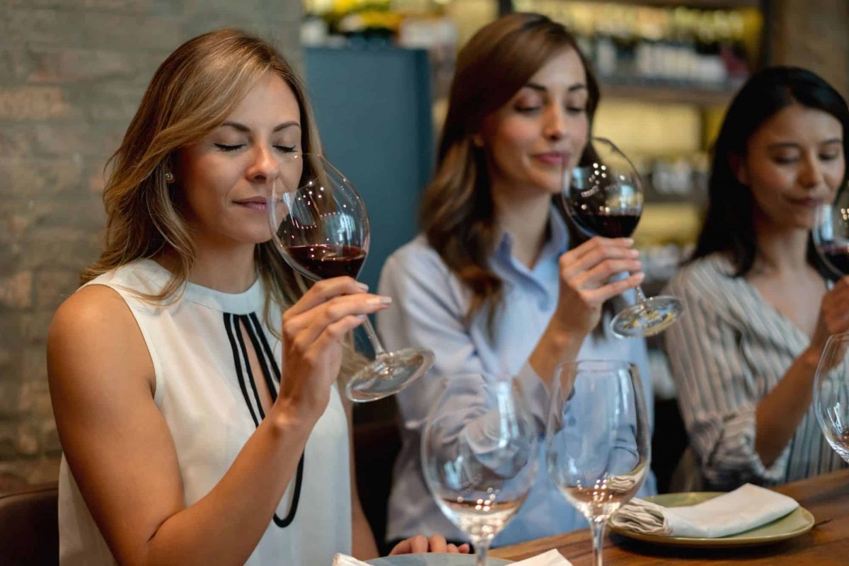 a group of women tasting wine