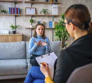 a woman and a counsellor talking in an office