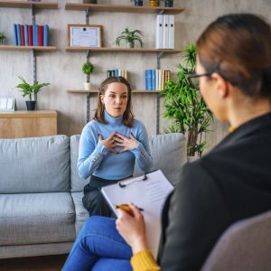a woman and a counsellor talking in an office