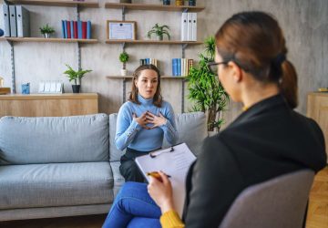 a woman and a counsellor talking in an office