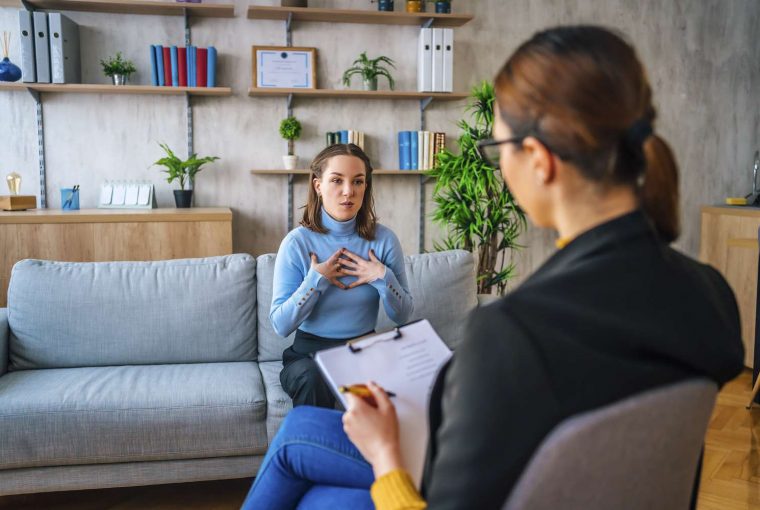 a woman and a counsellor talking in an office