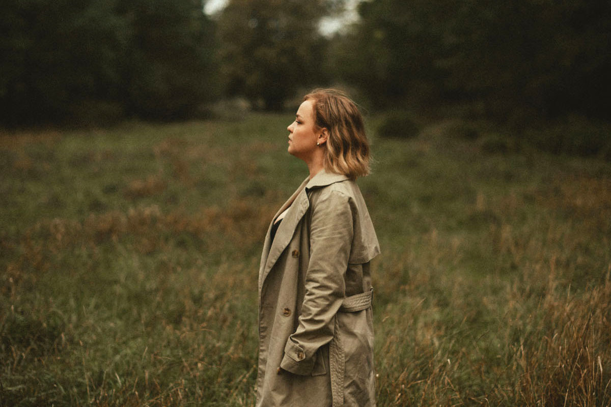 a woman standing in a field