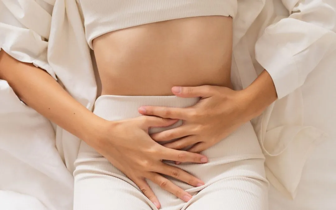 a woman with her hands on her abdomen