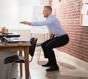 a man doing a workout at his desk