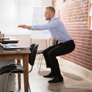 a man doing a workout at his desk