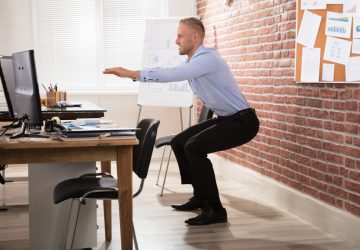 a man doing a workout at his desk