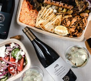 an assortment of takeout containers with wine bottles
