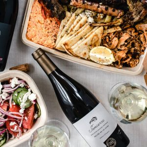 an assortment of takeout containers with wine bottles
