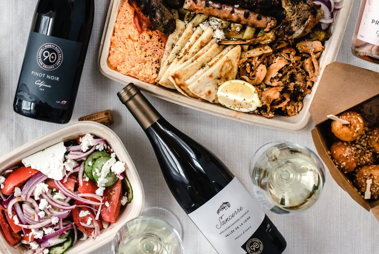 an assortment of takeout containers with wine bottles