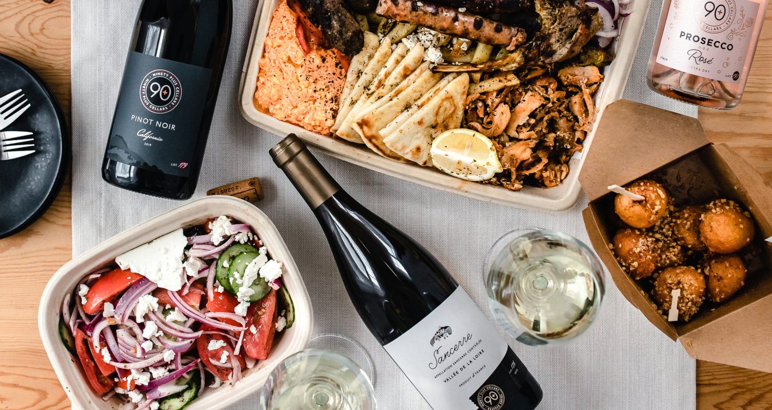 an assortment of takeout containers with wine bottles