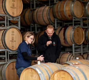 a pair sampling some oaked wine