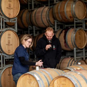 a pair sampling some oaked wine
