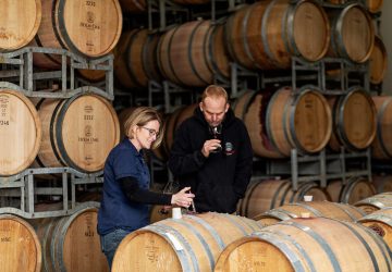 a pair sampling some oaked wine