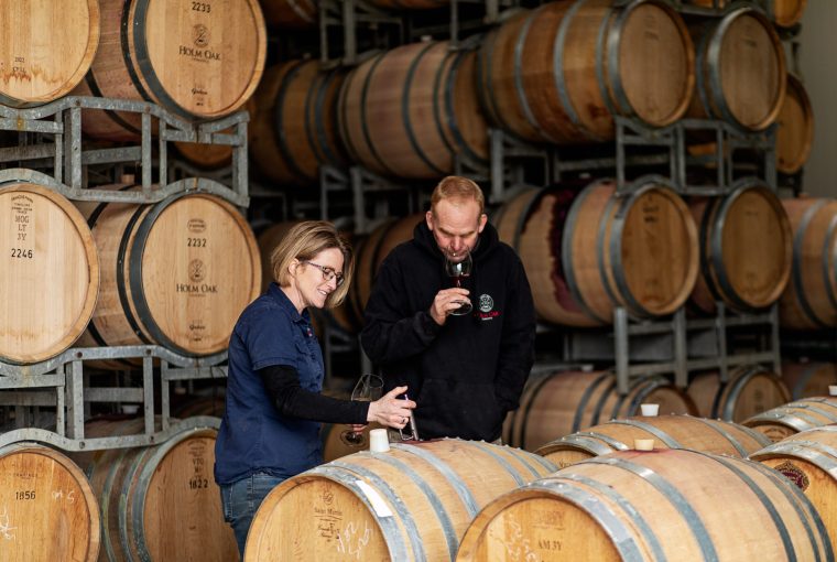 a pair sampling some oaked wine