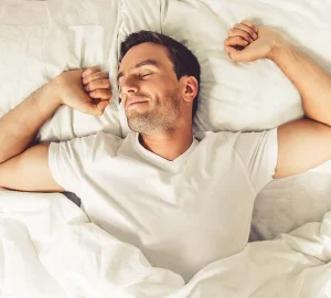 a man stretching in bed