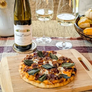 a riesling next to some fall food dishes