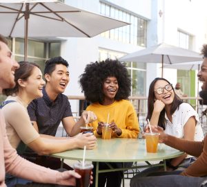 a group of friends laughing around the table