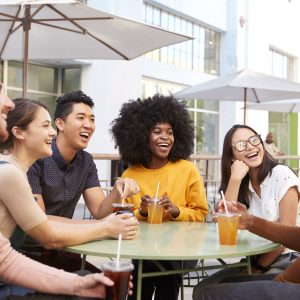 a group of friends laughing around the table