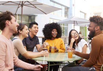 a group of friends laughing around the table